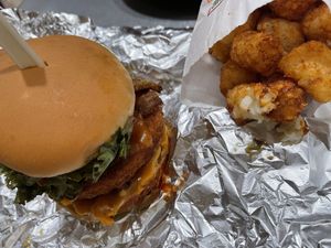 stacked chick’n burger with tater tots   at Next Level Burger - Roosevelt in Seattle