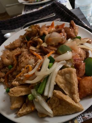 Full plate of vegan Chinese food, salt and pepper tofu not on the menu but they can make it for you. Cashews mock chicken and Kong Po Mock Chicken with Mock chicken fried rice at New Happy Palace  in Gillingham