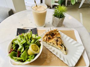 Leek and courgette quiche with salad, Greek iced coffee.   at Barbarella Juicebar in Ljubljana