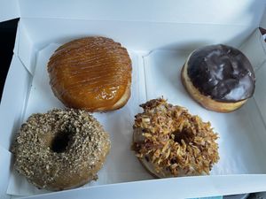 Vegan creme brûlée, boston cream, coffee pecan & maple coconut donuts! All very, very good! #Veganuary at Devi's Donuts and Sweets in Long Beach