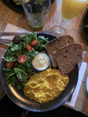 vegan tofu scrambled eggs with salad and bread (and a mimosa) 🌈  at Satsang in Prague