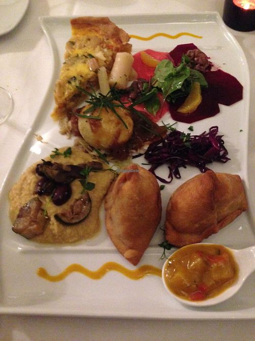 Mixed appetizer suitable for 3 people. It included 2 delicious samoosas; a carpaccio of red beet, walnuts, orange and baby mangold, a slice of quiche with salsify and dip; then a divine hummus with roasted vegetables and olive at Hollerei in Vienna