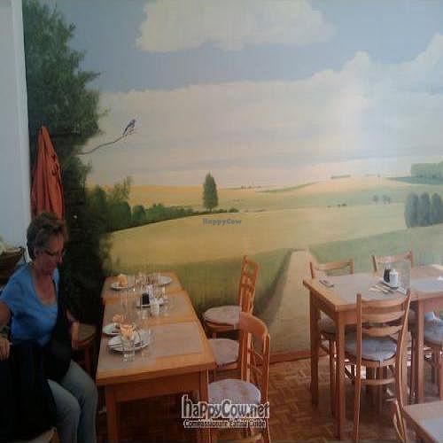 The cafe is decorated very simply with peaceful wall murals at Den Teepot in Brussels