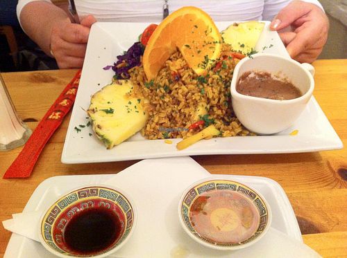 Gado Gado-
Crispy julienne of exotic & seasonal vegetables Indonesian style, with turmeric, brown rice, garnished with pineapple, orange & physalis. Served with sides of peanut sauce,plum sauce & Tamari soy. at Rainbow Vegetarian Cafe in Cambridge