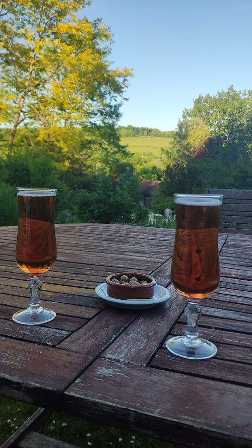 Kir Normand apéro outside overlooking the garden at La Maison du Vert in Ticheville