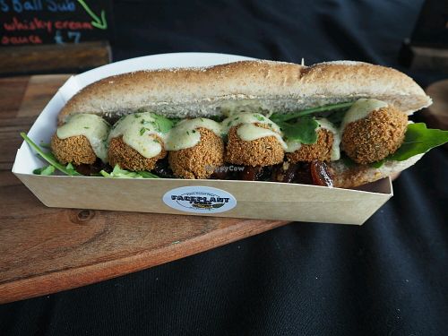 Haggis Balls sit on a bed of caramelised onion chutney, wild rocket and then covered in creamy whisky sauce at FacePlant Foods in Edinburgh