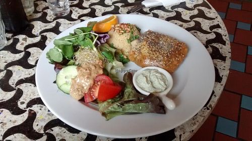 North African dish: couscous, a puff pastry with vegetables and tofu, salad and vegan raita at Bolhoed in Amsterdam