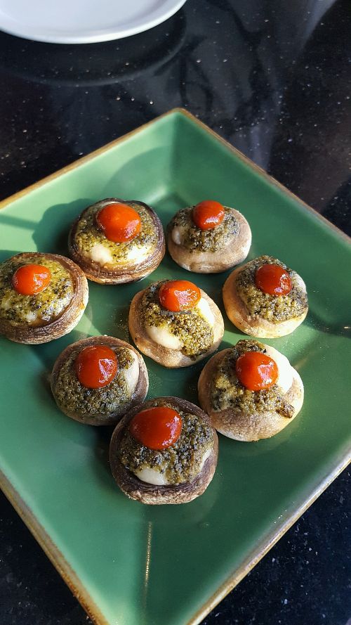 Siracha topped stuffed mushroom caps with cashew cheese and pesto at CyBelle's Front Room in San Francisco