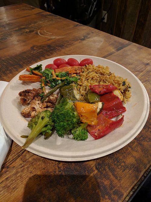 Variety of cooked vegetables, salads, and rice at Hudson Market in New York City