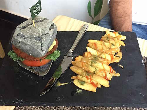 Home-made burger on charcoal bread bun with fries - so good!  at The Vegvolution Kitchen in Hong Kong Island