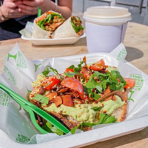 avocado toast with lots of jazzy toppings. coconut flat white. fried chickn wrap (background). at Serenity Now in Glasgow