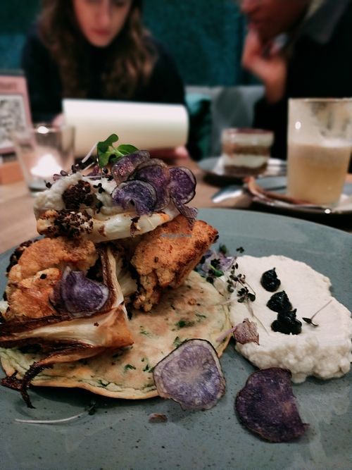 Roasted cauliflower with spinach pancake and garlic mash, purple crisps at Mana - Schöneberg in Berlin