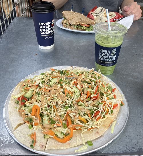 My Phuket pizza and oatmilk matcha latte (with brown sugar cinnamon syrup) and my partner’s chickpea salad sandwich and oatmilk coffee latte  at River Rock Roasting Company in La Verkin