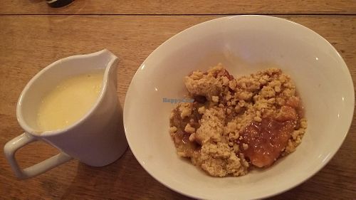 Apple & rhubarb crumble with custard (all vegan) at Peaky Blinders Bar  in Paignton