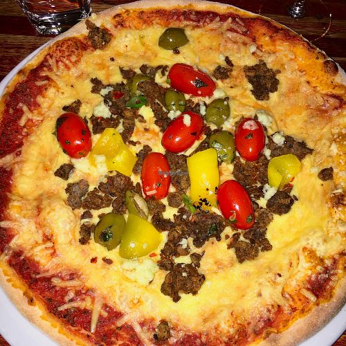 Vegan pizza with pulled broad beans, tomato, olives and yummy vegan cheese.  at Virgin Oil Co in Helsinki