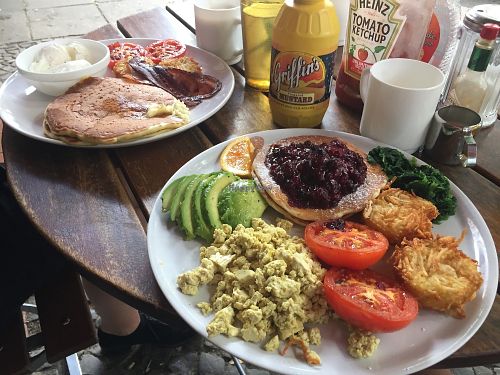 Vegan breakfast plate with pancakes and hash browns (foreground) - omni plate in background at Nalu Diner in Berlin