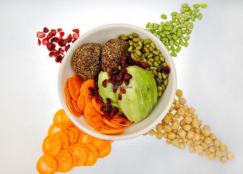 Quinoa and chickpea patty bowl. With seared edemame, pickeled carrots, a whole avocado and organic dried cranberries. Served with a spicy dressing at Fresco Gelateria in New York City