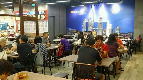 dining area in the food court. picture of Petronas twin towers in the background  at Da Jia Fa 大家发素食 - Jurong Point 2 in West Singapore