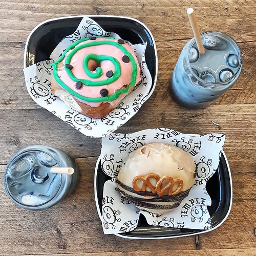 Salted caramel pretzel doughnut and watermelon with choc chips, plus two activated coal lattes. at Temple Coffee and Donuts in Leeds