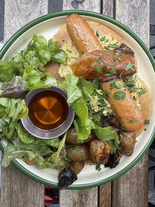 Brunch plate: pancakes, sausage, scrambled eggs  at Aujourd'hui Demain Cafe in Paris