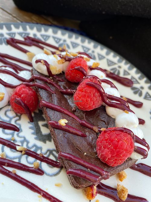 Brownie with red fruits and cream. at Bosque in Sintra