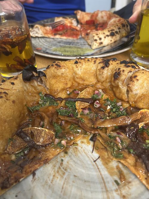 The bbq pizza with orange & margarita in back  at Vegazzi Specialty Pizzeria in Budapest