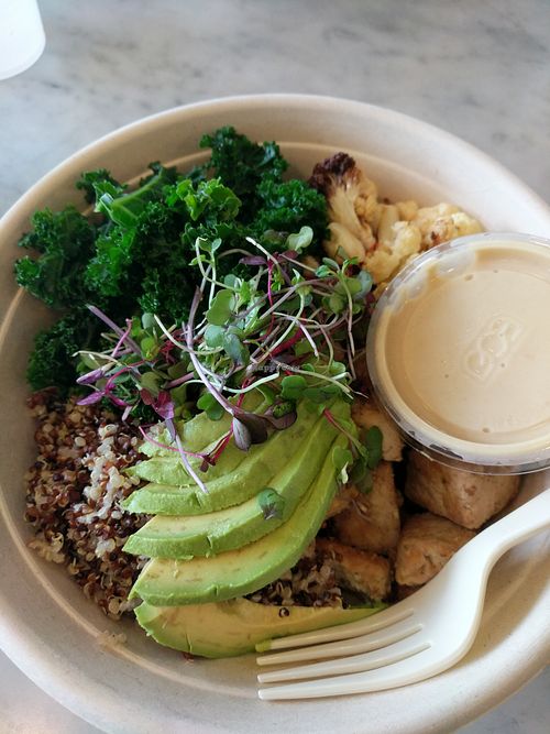Vegan bowl with tri-coloured quinoa, baked tofu, kale, cauliflower + roasted red pepper, avocado, microgreens and tahini citrus miso dressing at Honest Mary's in Austin
