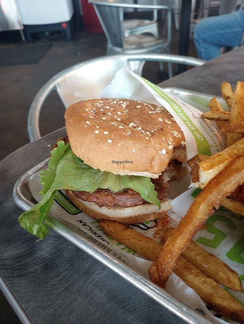 Beyond burger, with one bit out . "Make it vegan" at BurgerFi in Auburn