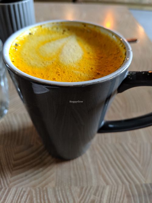 turmeric latte with oat milk at W6 Garden Centre Cafe in West London