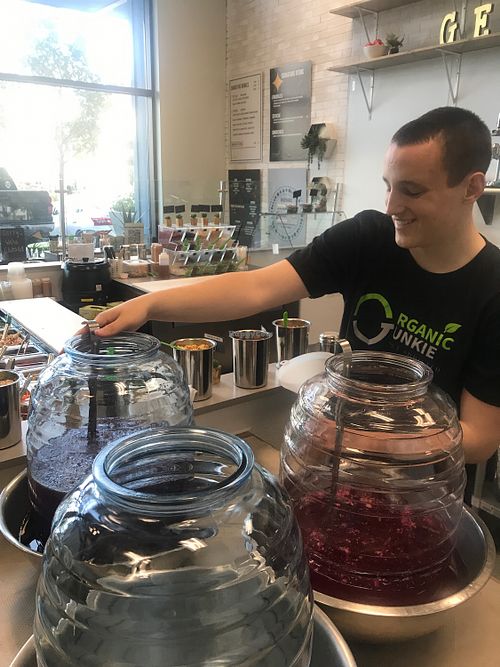 Filling my reusable container ... loving their fresh daily juices wow purple lemonade l at Organic Junkie in Corona