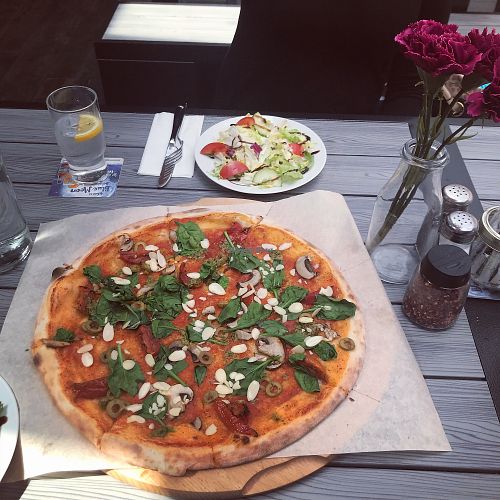 Vegan pizza with olives, mushrooms, sundried tomatoes, spinach, flaked almonds and pesto. at Cobblestone Joes in Limerick