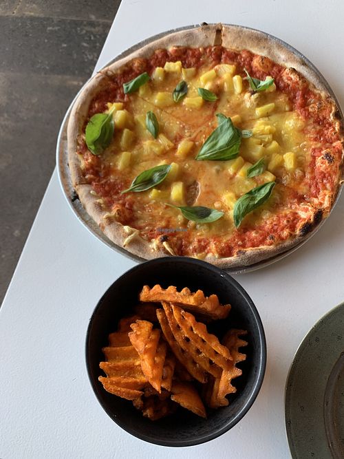 Waffle sweat potato fries and pizza w vegan cheese, pineapple and basil  at Olverk Pizza & Brewery in Hveragerdi