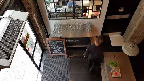 Entry area, with menu and kitchen view from upper floor at Dobra Karma in Wroclaw