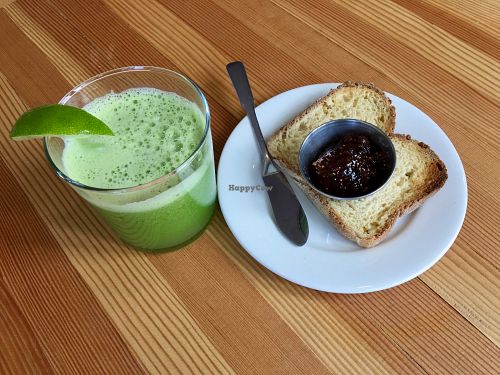 Green juice and gluten-free toast with fig jam. at Tiny Moreso in Portland