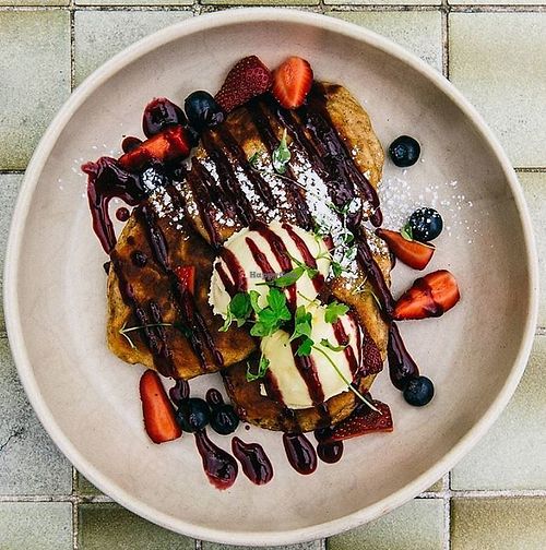 Vegetarian Banana Hotcakes - banana, berry coulis, mixed berries, chia and passionfruit mascarpone at The Resident Cafe in Ashburton