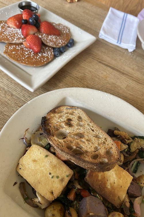 Farmer’s Daughter and Banana Pancakes. Pancakes give you access to the pancake bar with extra toppings like fruit and nuts.   at Portage Bay Cafe - Ballard in Seattle