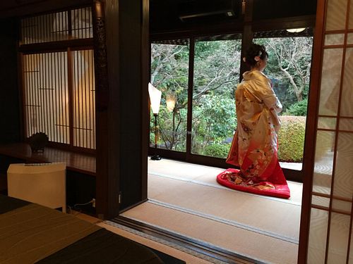 newlywed bride having her wedding photo taken next to our dining room at Kanga An in Kyoto