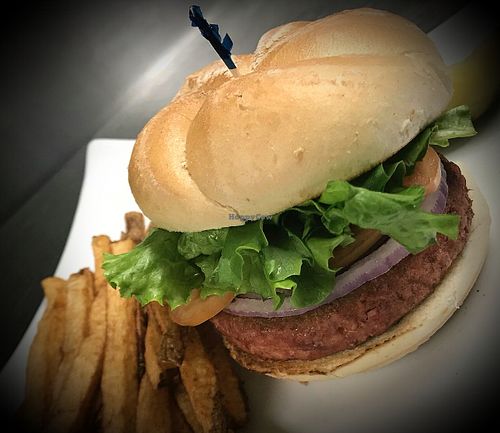 Burger served with lettuce, tomato, onion, & fresh cut fries  at The Tipsy Turtle in Dupont