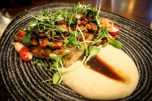glazed tempeh with cloudberries, millet and mashed parsley  at Mazā Terapija in Riga