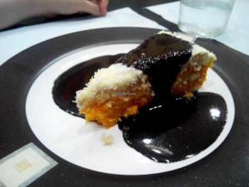 Coconut and carrot cake served with a chocolate sauce. at Garibolo in Bilbao