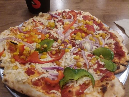 A customized pizza I got with vegan cheese, peppers, onions and corn on their thin crust which is vegan. at Pie Five Pizza in Estero