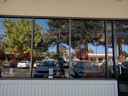 Dark front glass of the restaurant at Merit Vegan Restaurant in Sunnyvale