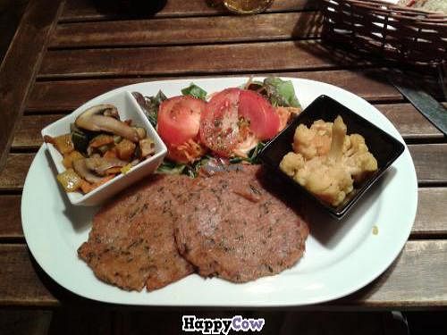 Seitan cutlets, fried vegetables, cauliflower and green salad at El Vegetariano de la Alcazabilla in Malaga