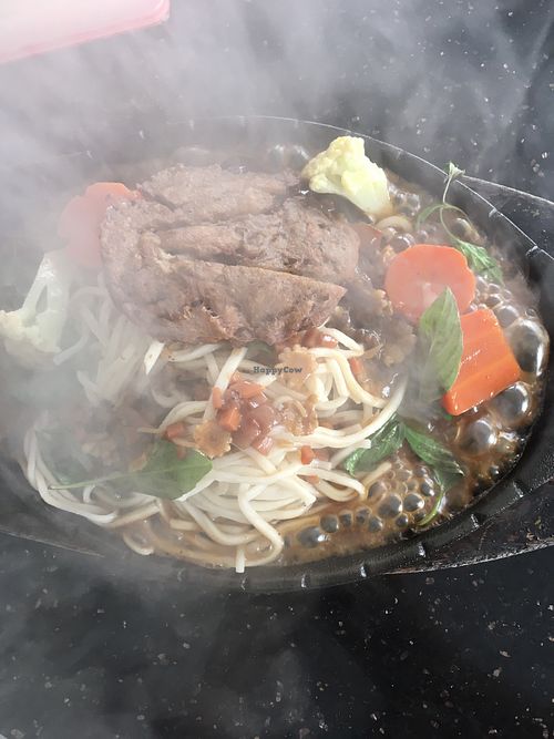 Mock pork chop with noodles on a sizzling plate (menu calls it vegetable chop noodle teppanyaki). Requested no egg to make it vegan.  at Monorom Garden in Battambang