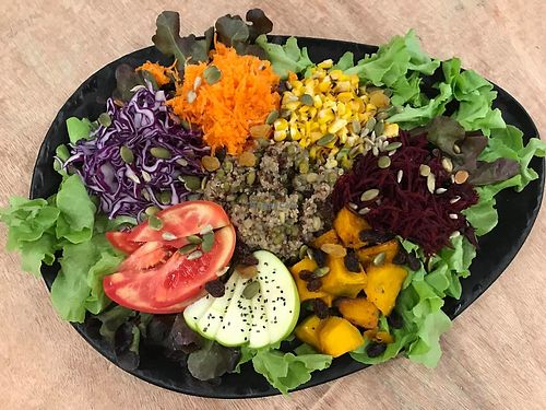 Quinoa and Rainbow Veg Salad - quinoa, lentils and mung beans surrounded by colourful veg, topped with raisins,  nuts and seeds and served with a dressing of choice. at Nourish Cafe in Bangkok