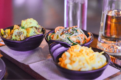 Sides of vegan Mac n’ cheese, cucumber salad, curried cauliflower  at Chappaqua Station in Chappaqua