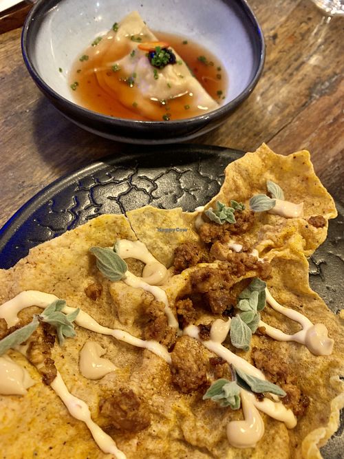 Tofu Empanada (rice cracker with braised tofu, vegan creme fraiche), ordered in advance & Squash dumpling. at Pobrecito in Helsinki