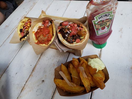 Three servings: the red, yellow and kebab dishes, and french fries. at Cookoomela Grill in Athens