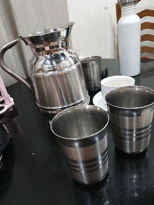 Stainless steel jug & cups free filtered water. at Grandma's Kitchen in Kochi