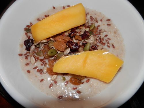 Porridge made with coconut milk and topped with dried fruit, seeds and mango at Caffe Nero in Spalding